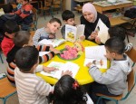 photo - Children in Baka al-Gharbiyah enjoying Maktabat al-Fanoos books and working with their teacher on their storytelling skills
