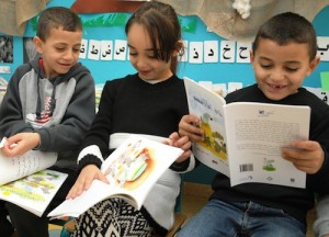 photo - reschoolers in Baka al-Gharbiyah receiving their picture book, to enjoy at school and with their families at home