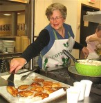 photo - Avodah volunteer Daryl Levine makes latkes for last year's latke lunch during Chanukah