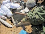 photo - Gaza, July 28, 2014: An Israel Defence Forces soldier examines a newly revealed tunnel in the Gaza strip