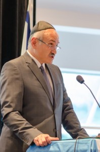 photo - Farid Rohani, a businessman, social activist and a board member of the Laurier Institution, speaks to those gathered at Temple Sholom