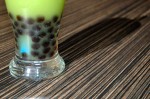 photo - Tapioca pearls cluster at the bottom of a green apple Calpis green tea