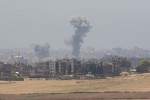 photo - Smoke rises in Gaza after an Israeli airstrike on the second day of Operation Protective Edge, July 9, 2014