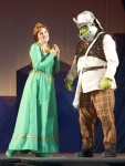 photo - When Fiona (Lindsay Warnock) asks her savior to take off his helmet so that she can meet her prince, Shrek (Matt Palmer) is reluctant