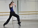 photo - Crystal Wills in rehearsal for The Way They Walked Through the World. The work includes the use of more than 300 pairs of army boots.