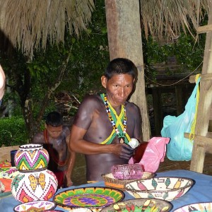 photo - Members of the Emberá tribe present their wares for sale, including their brightly colored woven baskets