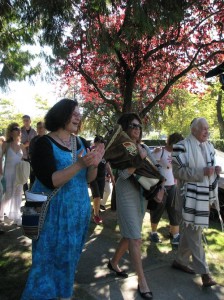 photo - Baalat Tefillah Debby Fenson and congregants escort the Torah to its new home