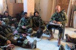 photo - Israel Defence Forces soldiers debrief during the Israel-Hamas conflict