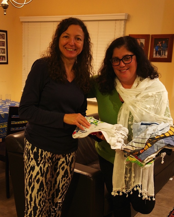 photo - Sarah Marel Schaffer, left, and Sandy Hazan pause while sorting clothing for Operation Dress-Up, a social action project sponsored by the National Council of Jewish Women, Vancouver section