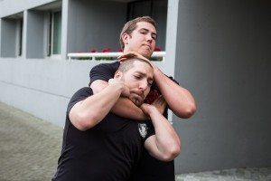 photo - Krav maga instructor Jonathan Fader prepares to get out of a choke hold