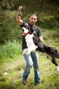 photo - Ofer Biton with a therapy dog. The dog is the tool for the therapist, facilitating the initial connection with the client