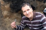 photo - Hartley Odwak holds a 1,000-2,000-year-old stone projective point recovered from one of the sites on which he has worked