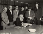 photo - A visiting dignitary signs the VIP guest register as others look on, Congregation Schara Tzedeck, 1974