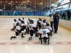 photo - Canada Israel Hockey School students listen to skating coach Barb Adelbaum.