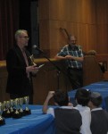 photo - Dr. Neil Pollock hands out some of the awards, as Larry Barzelai and student participants look on