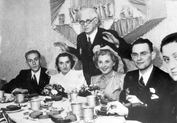 photo - This photo is among the images in The Face of the Ghetto: Pictures Taken by Jewish Photographers in the Litzmannstadt Ghetto, 1940-1944, produced by the Topography of Terror Foundation, Berlin. The bride on the right is Bronia Sonnenschein; beside her is her groom Erich Strauss. The second bride is Mary Schifflinger with husband Ignatz Yelin. Blessing the couples is Chaim Rumkowski, head of Lodz Ghetto’s Jewish council. Only Sonnenschein survived the Holocaust. She passed away in Vancouver in 2011