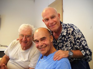 photo - Alberto Lukacs-Böhm, right, stands behind Golden Rainbow members Nitzan Aviv and David Goldstein, centre