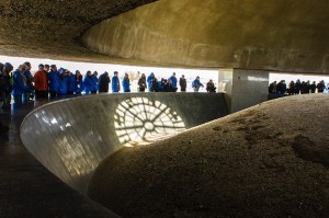 photo - Participants in March of the Living stand together in front of the ashes of those murdered in the concentration camp, Majdanek