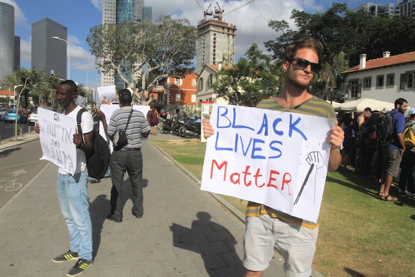 photo - Ethiopian Jews and their supporters protest outside the Ministry of Defence headquarters in central Tel Aviv, June 2015.