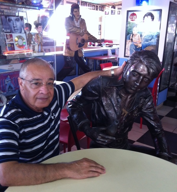 photo - Uri Yoeli, left, at the Elvis Inn, his restaurant/convenience store/gas station in Neve Ilan