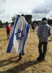 photo - Dor Brown wrapped in the Israeli flag as he approaches Treblinka death camp