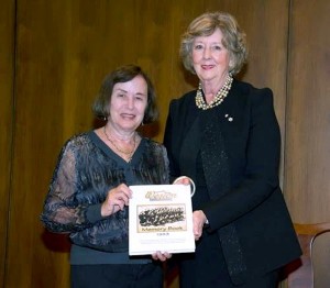 photo - Weston Girl Estelle Sures, left, presents a memory book of the Weston Girls tour to Manitoba Lieutenant Governor Janice Filmon