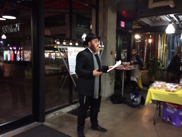 photo - Chabad of North Shore Rabbi Mendy Mochkin speaks at the first-ever menorah lighting at Lonsdale Quay