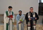 photo - In Petriplatz, Pastor Gregor Hohberg, left, and Imam Kadir Sanci listen as Rabbi Andreas Nachama recites a prayer for peace