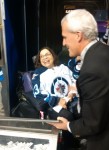 photo - At a Winnipeg Jets game, Judith Heumann, U.S. special advisor on international disability rights, speaks to hockey fans and draws the winning 50/50 ticket