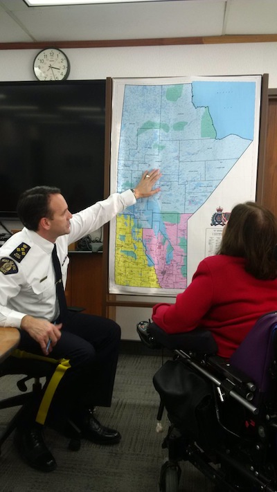 photo - Judith Heumann meets with Manitoba’s Royal Canadian Mounted Police Chief Kevin Brosseau to discuss issues around persons with disabilities and the challenges they face in traveling