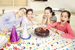 photo - Deborah French’s children – Henry, Elisheva, Amariah and Rafaella – about to enjoy the fruits of their labor, having made their first chocolate cake. French published The Cookbook for Children with Special Needs in 2015