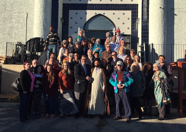 photo - Imam Syed Hadi Hasan, right centre, takes Rabbi Shaul Osadchey, left centre, and some congregants on a tour of his mosque