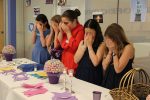 photo - Grade 6 students from Vancouver Talmud Torah – Sophie Chelin, Ava Abramowich, Sayde Shuster, Ruth Nahmad and Rachel Seguin – do the blessing over the candles at an interfaith Shabbat dinner on May 6