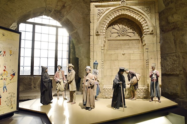 photo - The above display at the Tower of David Museum shows a variety of characters typical of Jerusalem in the 19th century in front of a fountain. Jerusalem’s water system was restored during the rule of Sultan Suleiman the Magnificent; fountains (sabils) were built throughout the city, providing water to its residents and to visitors for generations