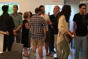 photo in Jewish Independent - Panelists Tom Davidoff, second from the left, and Michael Geller, third from the right, mingle with the crowd at the Community Kollel on June 28