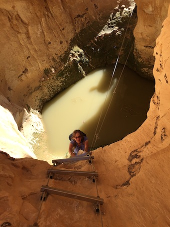 photo - Jennifer Williamson climbs up a ladder after she and hiking partner Arlene Doyle had to trek through a pool of water