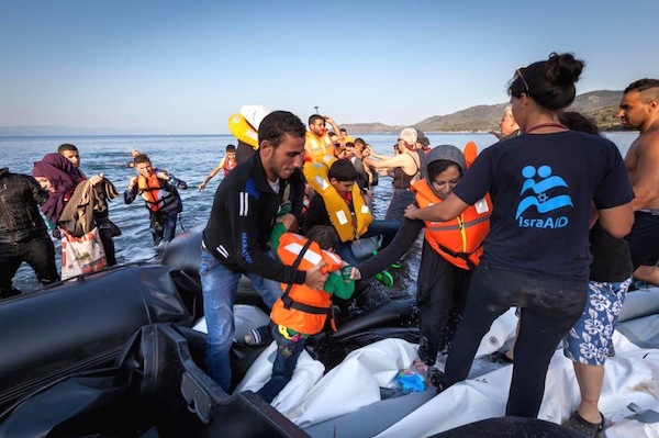 photo - Medical and rescue teams from IsraAID attend to Syrian refugees who have just landed in a rubber boat on the Greek island of Lesbos after the perilous crossing from Turkey