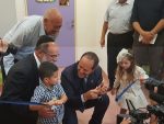 photo - Shalva founder Kalman Samuels, left, and Mayor of Jerusalem Nir Barkat, centre, help youngsters cut the ribbon at the grand opening of the new Shalva National Children’s Centre