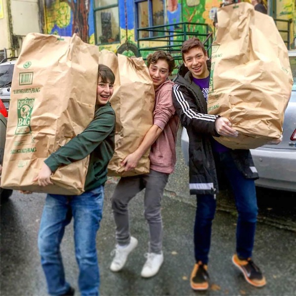 photo - King David High School Grade 8 students Noam, Judd and Joey, collecting bread from COBS