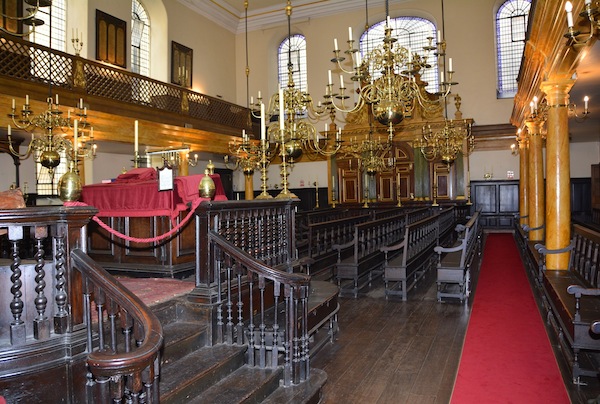 photo - The interior of Bevis Marks Synagogue looking towards the ark and with the bima in the left foreground. The ark is made of oak, but painted to look like Italian marble, as are the supports to the ladies gallery