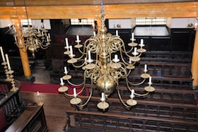 photo - The central candelabrum, one of seven that hang in Bevis Marks, was a gift from the community of Amsterdam at the time of its original construction