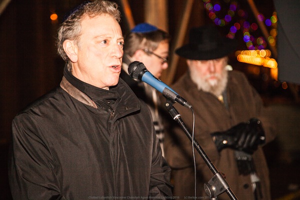 photo - MLA George Heyman addresses the crowd at the lighting of the Silber Family Agam Menorah (below) on Dec. 25