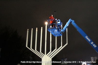 photo - Michael Sachs, president of the Bayit, lights the menorah outside of Richmond Public Library and Cultural Centre on Dec. 26