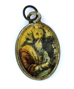 photo - A metal locket covered by glass with the image of Moses holding the Ten Commandments painted on it. (photos from IAA via Ashernet)