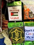 photo - Only in Israel? A leisurely walk through Jerusalem’s Old City will let visitors see many manifestations of political propaganda, packaged in many forms, all sold to the visitor with a smile. Here, a “Free Palestine” T-shirt is offered for sale in the shuk alongside an Israel Defence Forces T-shirt