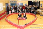 photo - Rose’s Angels co-founders Courtney Cohen, left, and Lynne Fader, surrounded by some of the 60 volunteers who came out Feb. 12 to make 1,000 care packages for those less fortunate