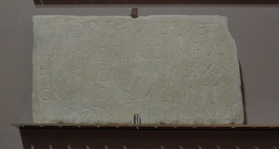 photo - The tombstone for the young Jewish Numerius, written in both Latin and Hebrew, which can be seen at the National Archeology Museum in Naples. Note the menorah in the middle of the bottom line