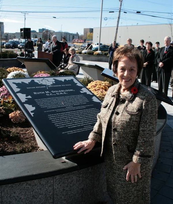 photo - Ruth Goldbloom stands in Nation Builder Plaza in front of the Canadian Museum of Immigration at Pier 21 in Halifax