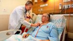 photo - Cardiologist Gil Bolotin checks patient Robert MacLachlan, the first in the world to receive the CORolla implant, at Rambam hospital