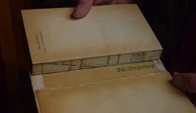 photo - In the spine of this 1947 edition of The Diary of a Young Girl is a piece of paper with the German words, “Die Vergeltung,” or retribution